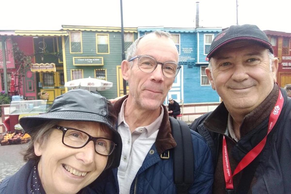 two men and a woman posing for a picture