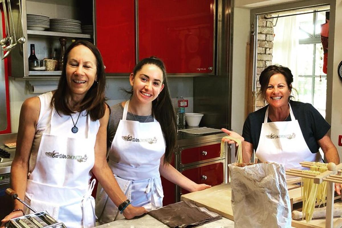 three women in a kitchen posing for a picture