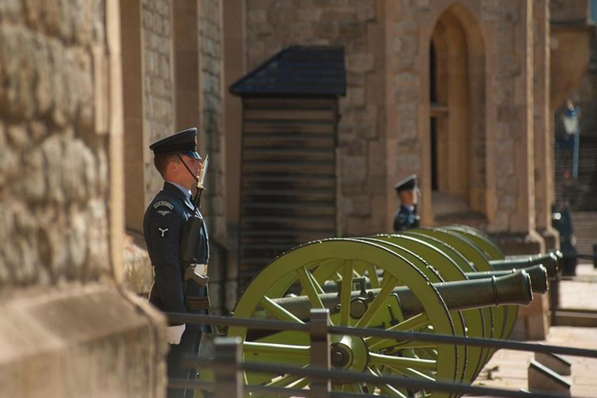 a toy soldier standing next to a row of green cannons