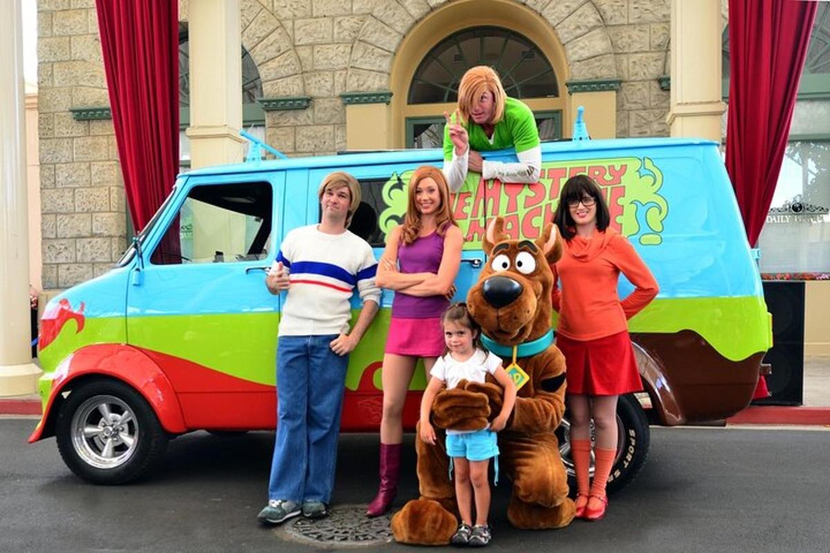 a group of people standing in front of a van