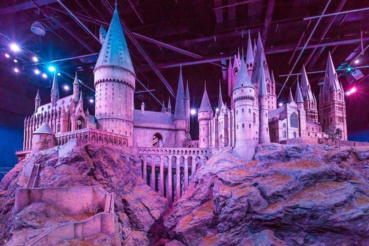 a castle on a mountain with lights on it