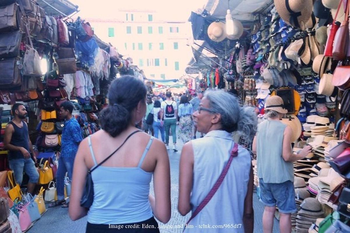 a group of people walking through a market