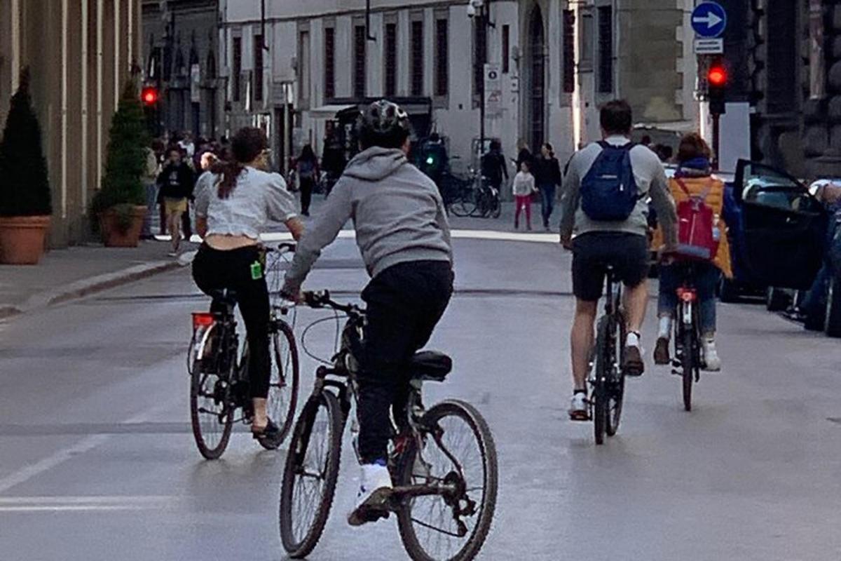 a group of people riding bikes down a street