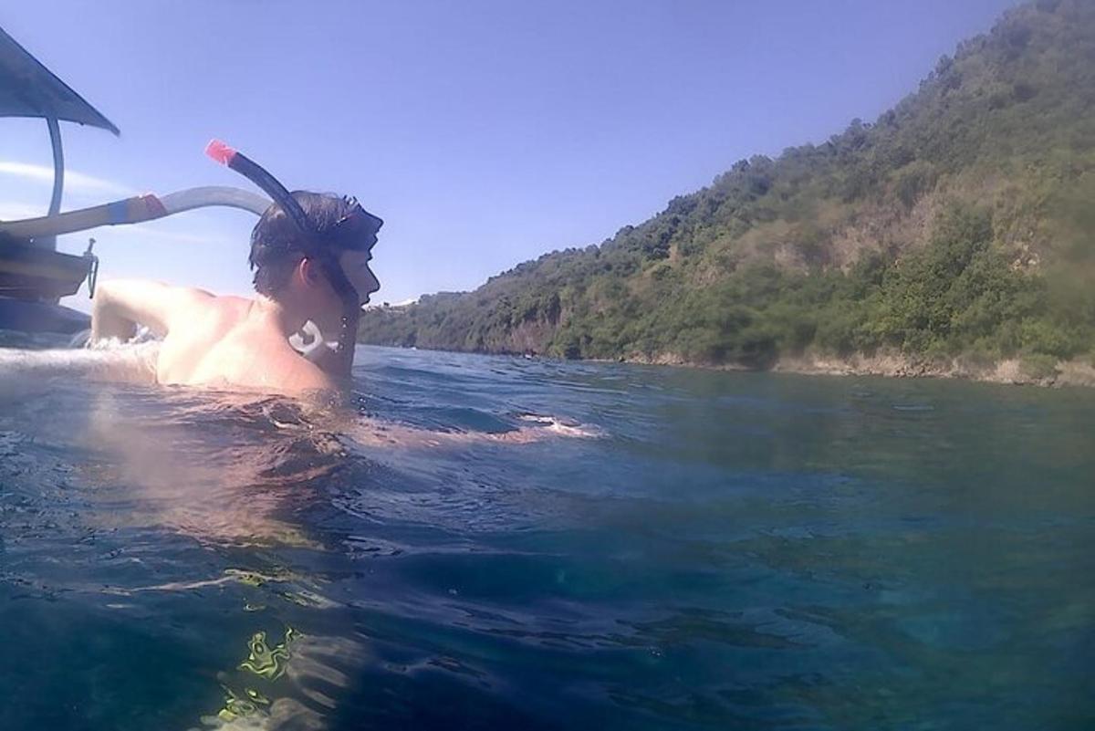a man in the water on a boat in a river