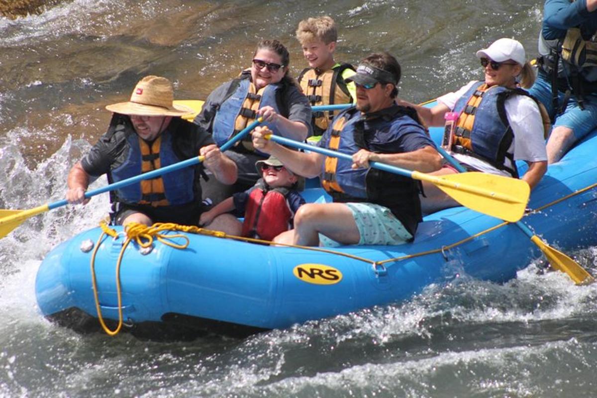 a group of people in a raft in the water
