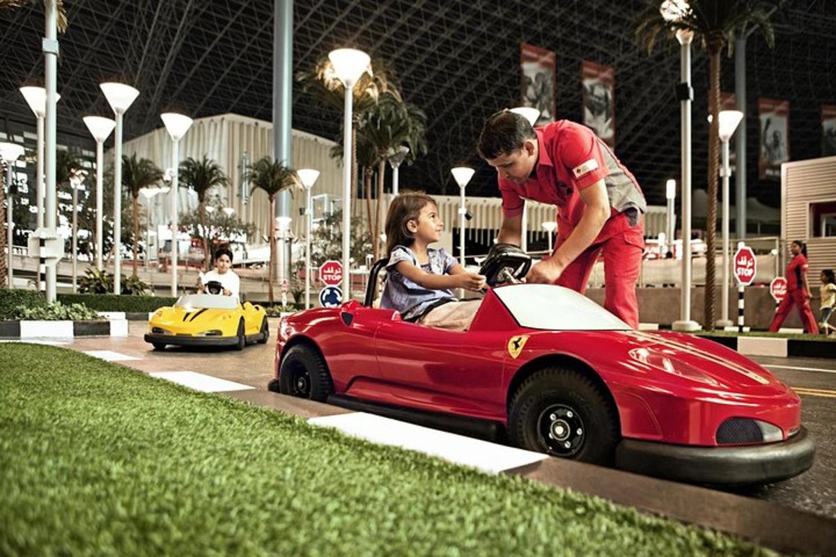 a man and a child playing in a toy car