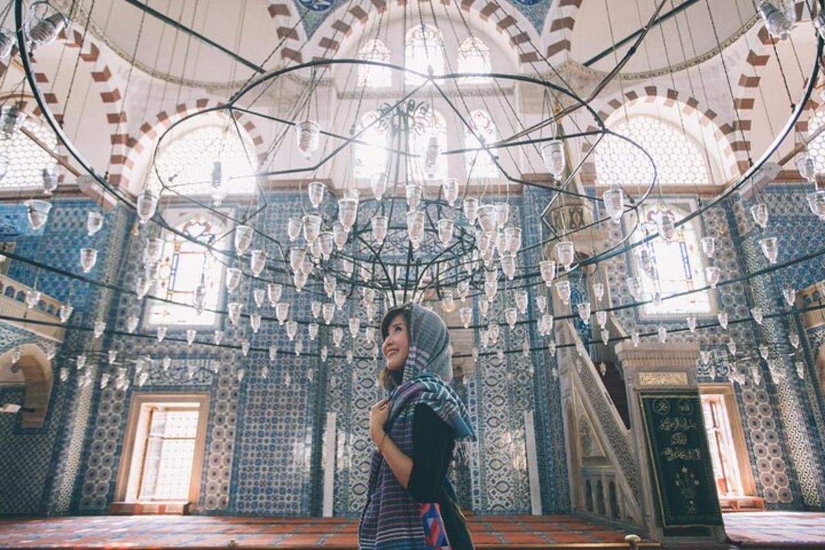 a woman standing in front of a building with a chandelier