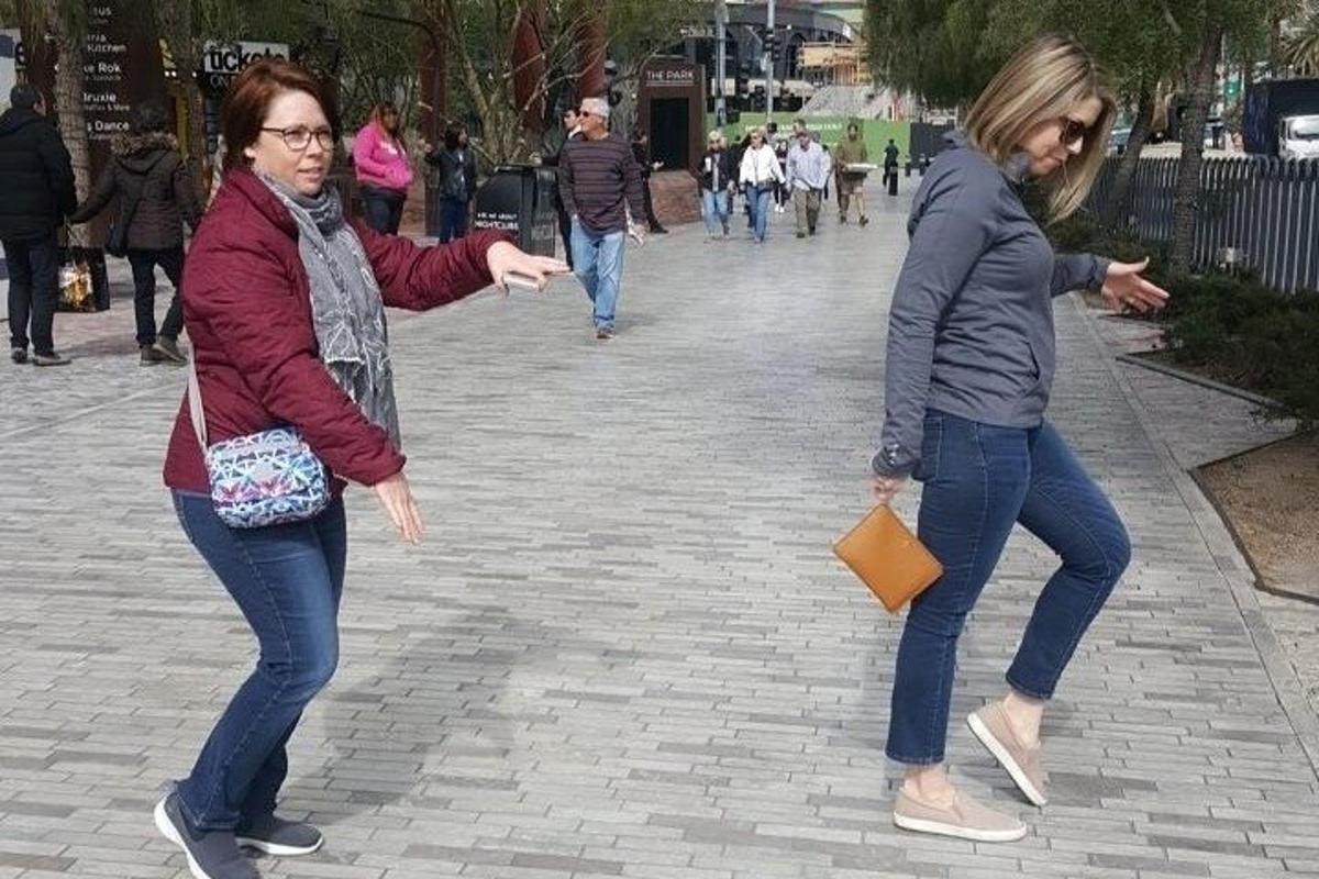 dues dones caminen per un carrer de maons