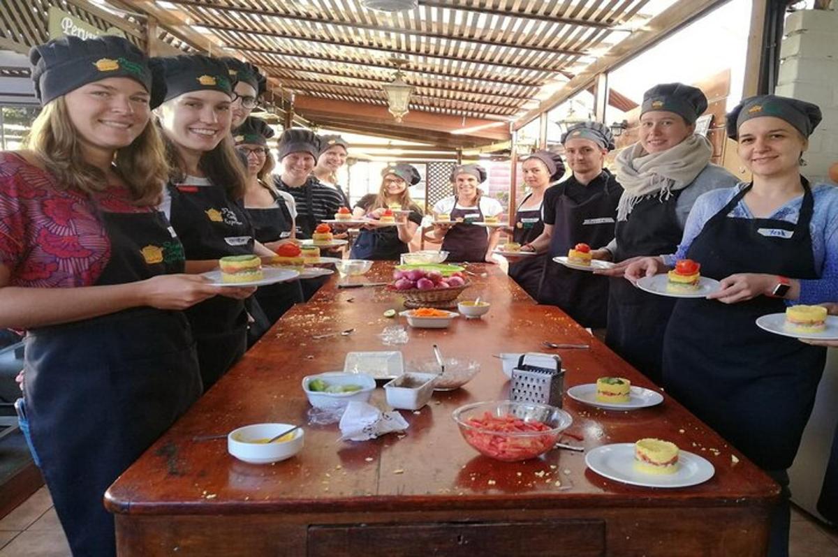 a group of people standing around a table with food