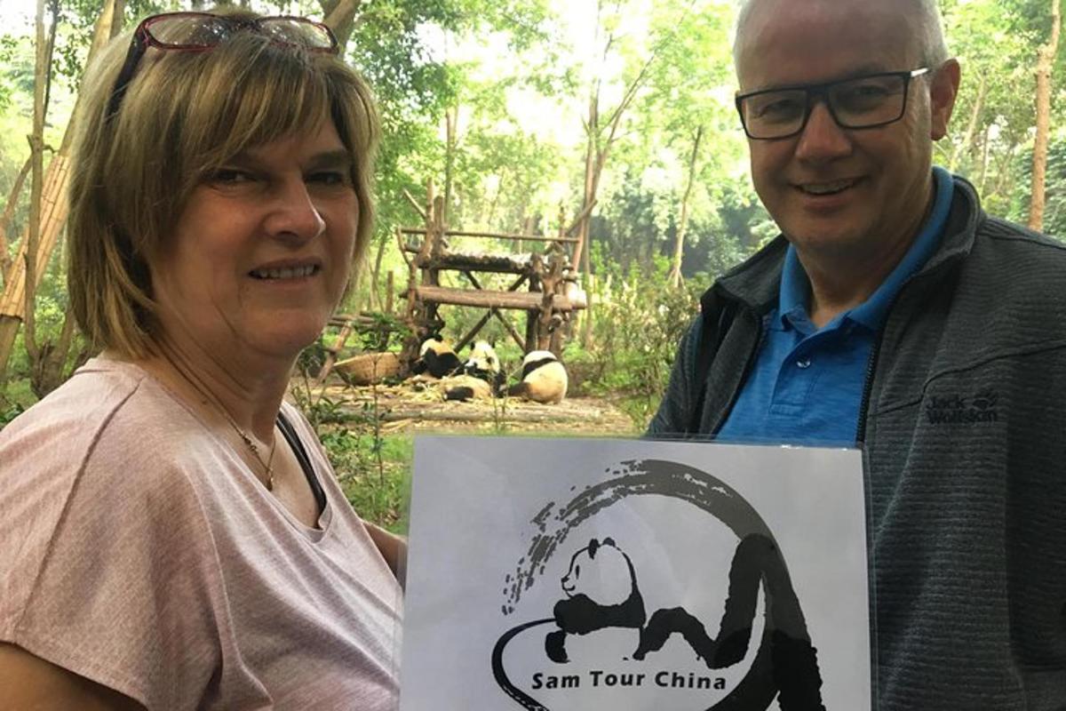 a man and woman holding a sign with a monkey on it