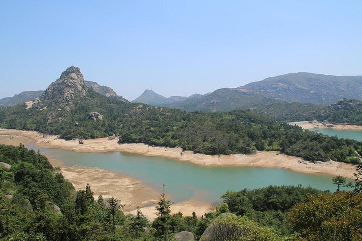 a view of a river with mountains in the background
