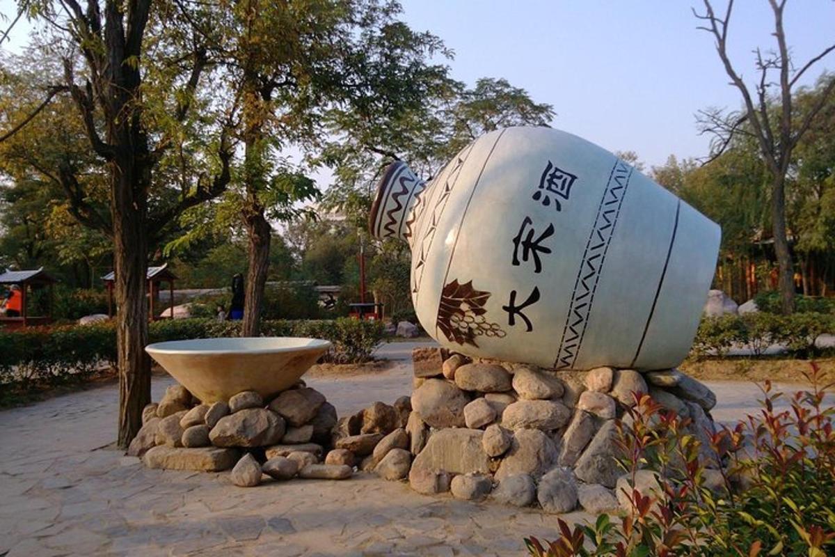 a statue of a ball on a pile of rocks