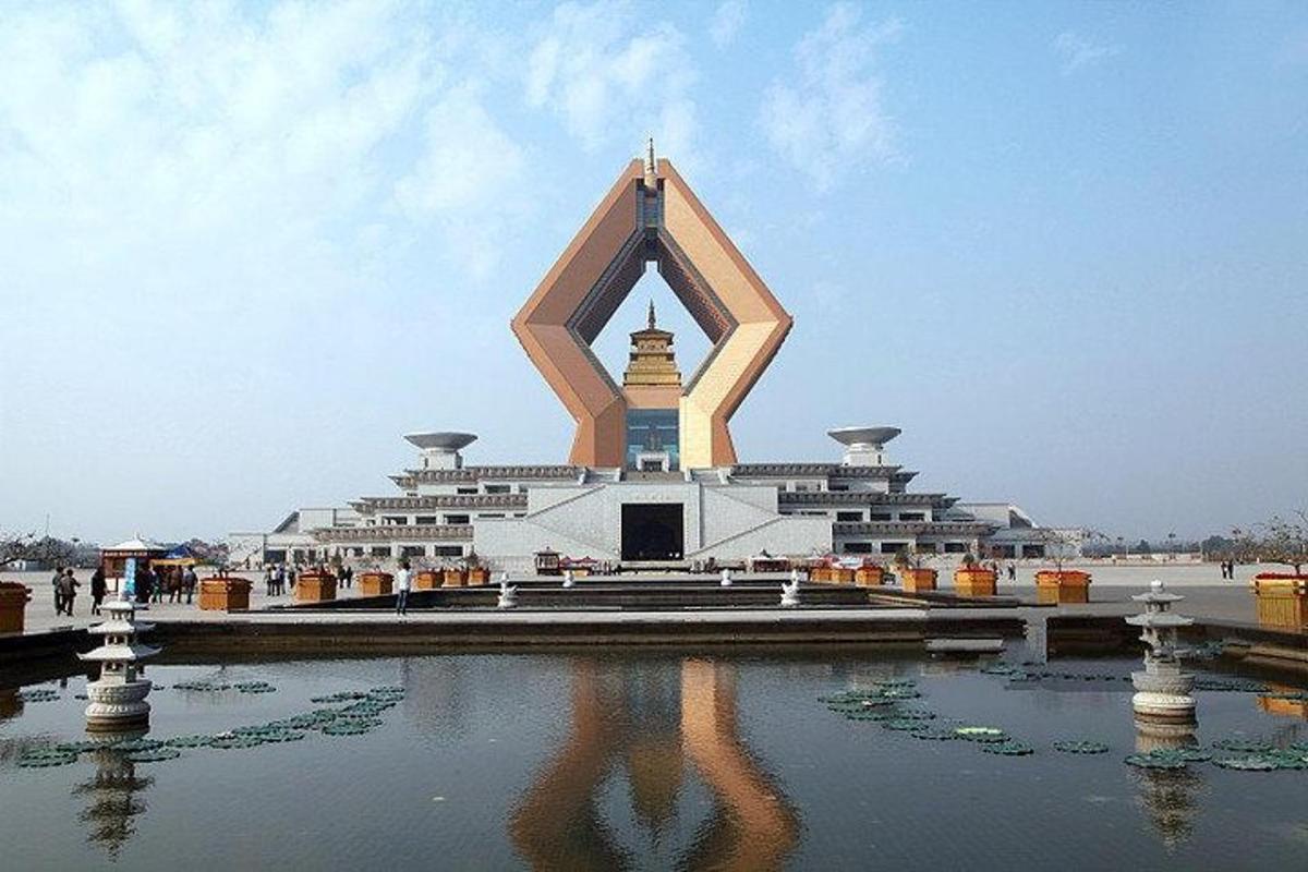 a large building with a reflection in the water
