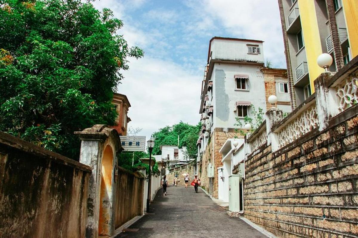 an alley in a city with people walking down it