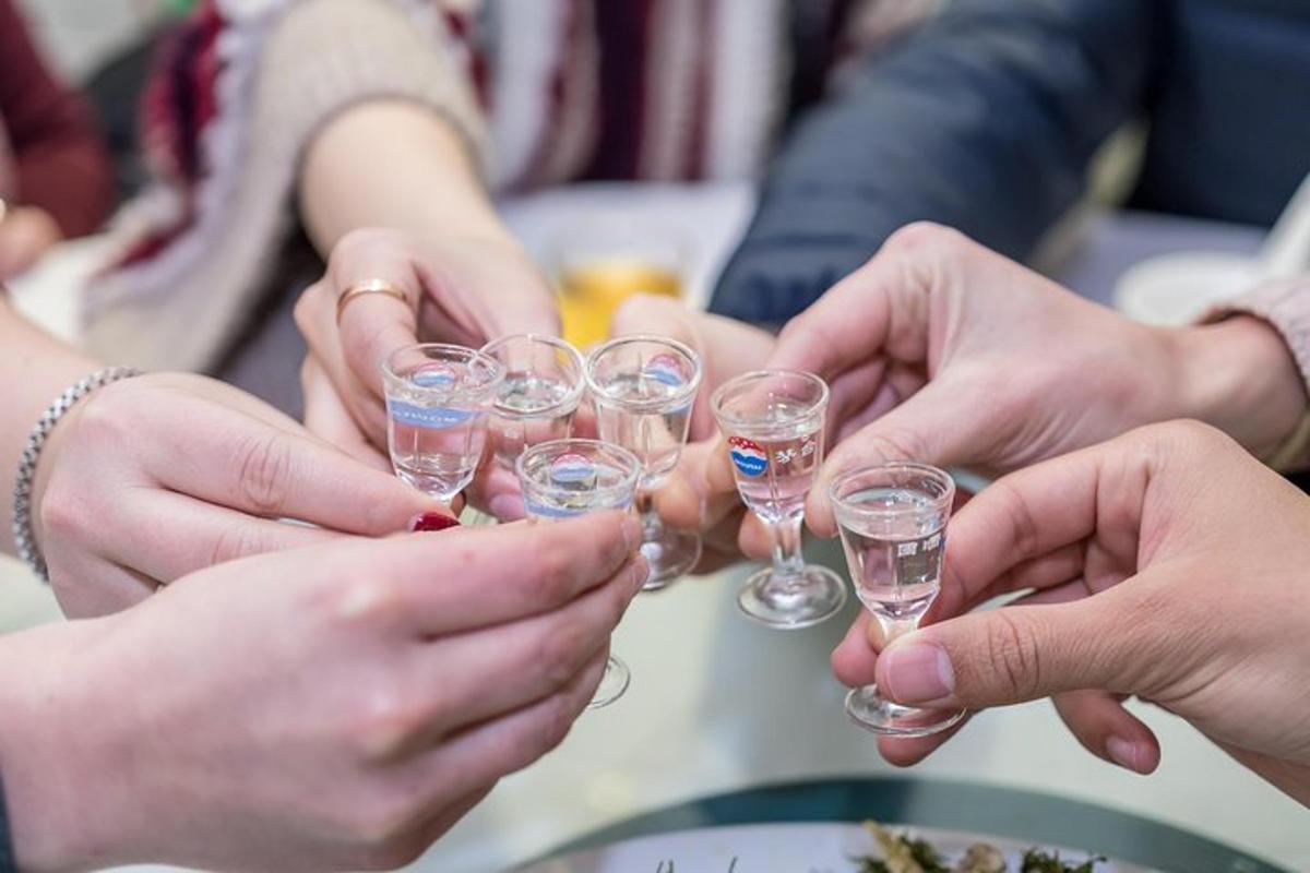 a group of people holding up wine glasses