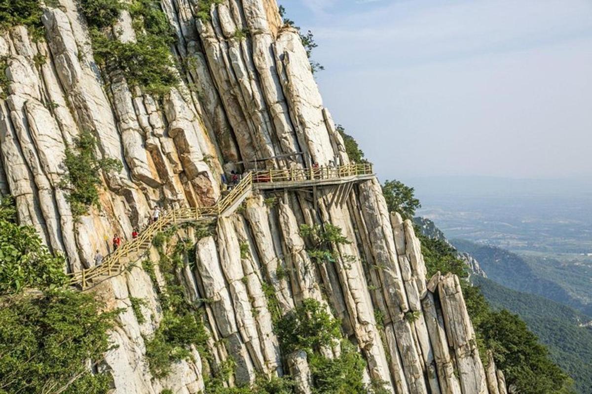 a group of people standing on the side of a mountain