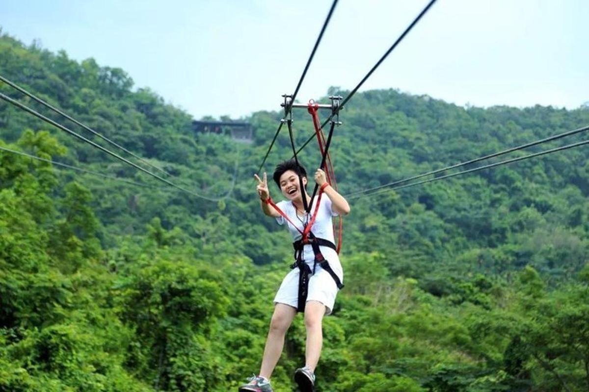 a person on a zip line in the jungle