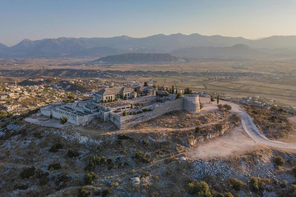 an aerial view of an old building on a hill