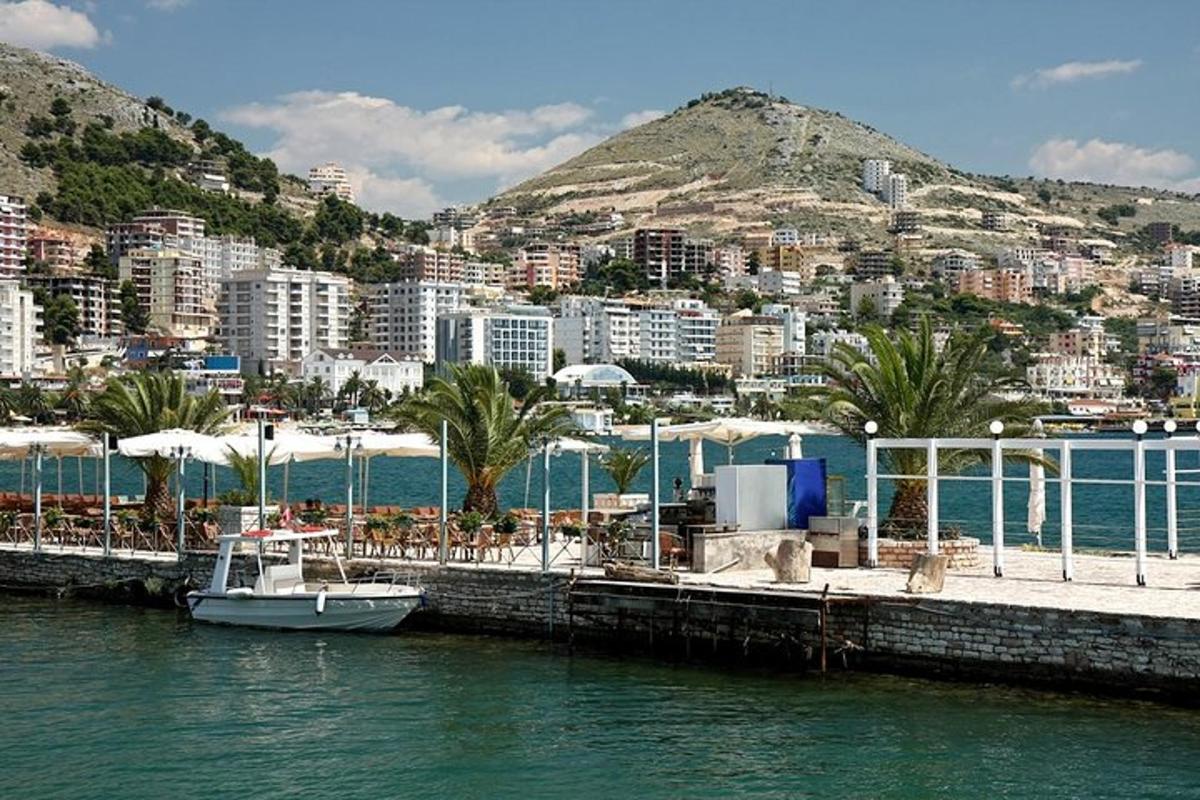 a boat is docked at a dock with a city