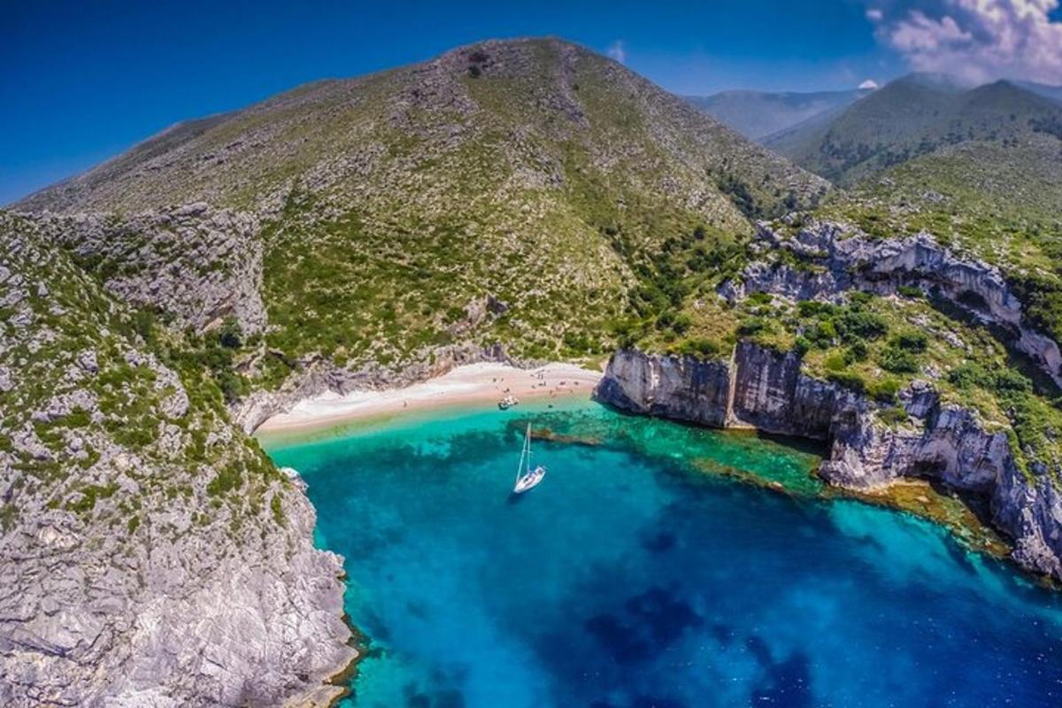 an island with a beach and a boat in the water