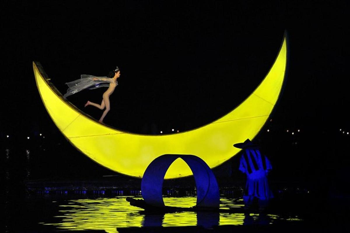 a woman sitting on the crescent moon at night