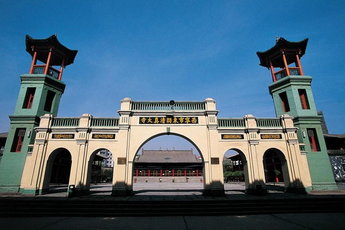 a large building with an arch in front of it