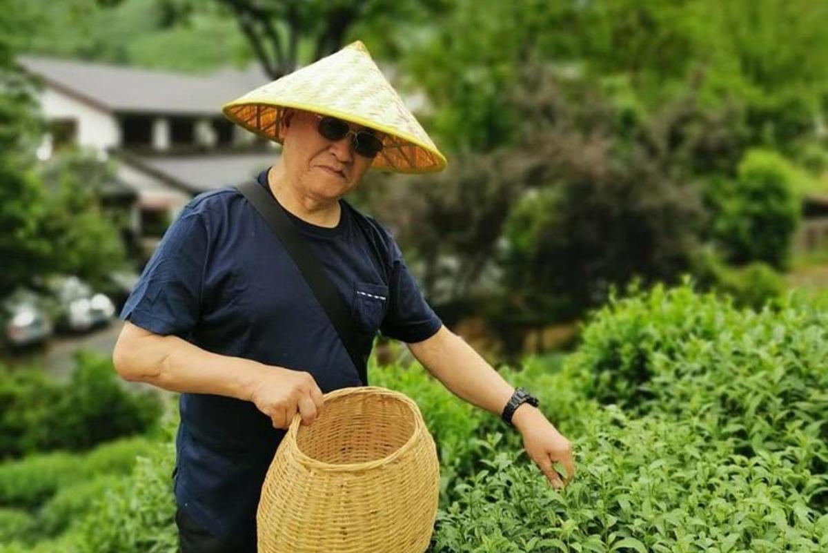 a man wearing a straw hat holding a basket