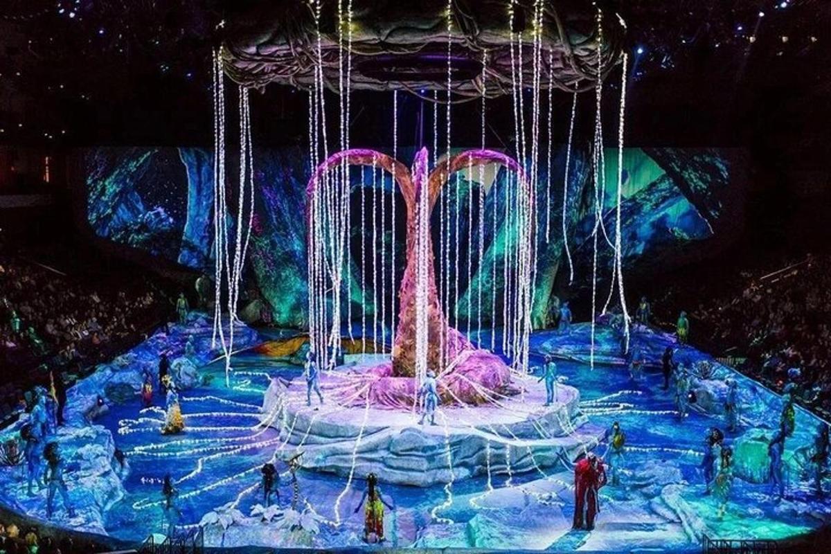 a stage with a fountain with people standing around it