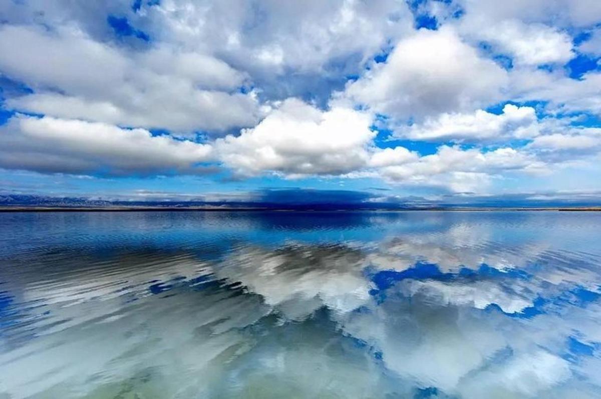 a large body of water with clouds in the sky