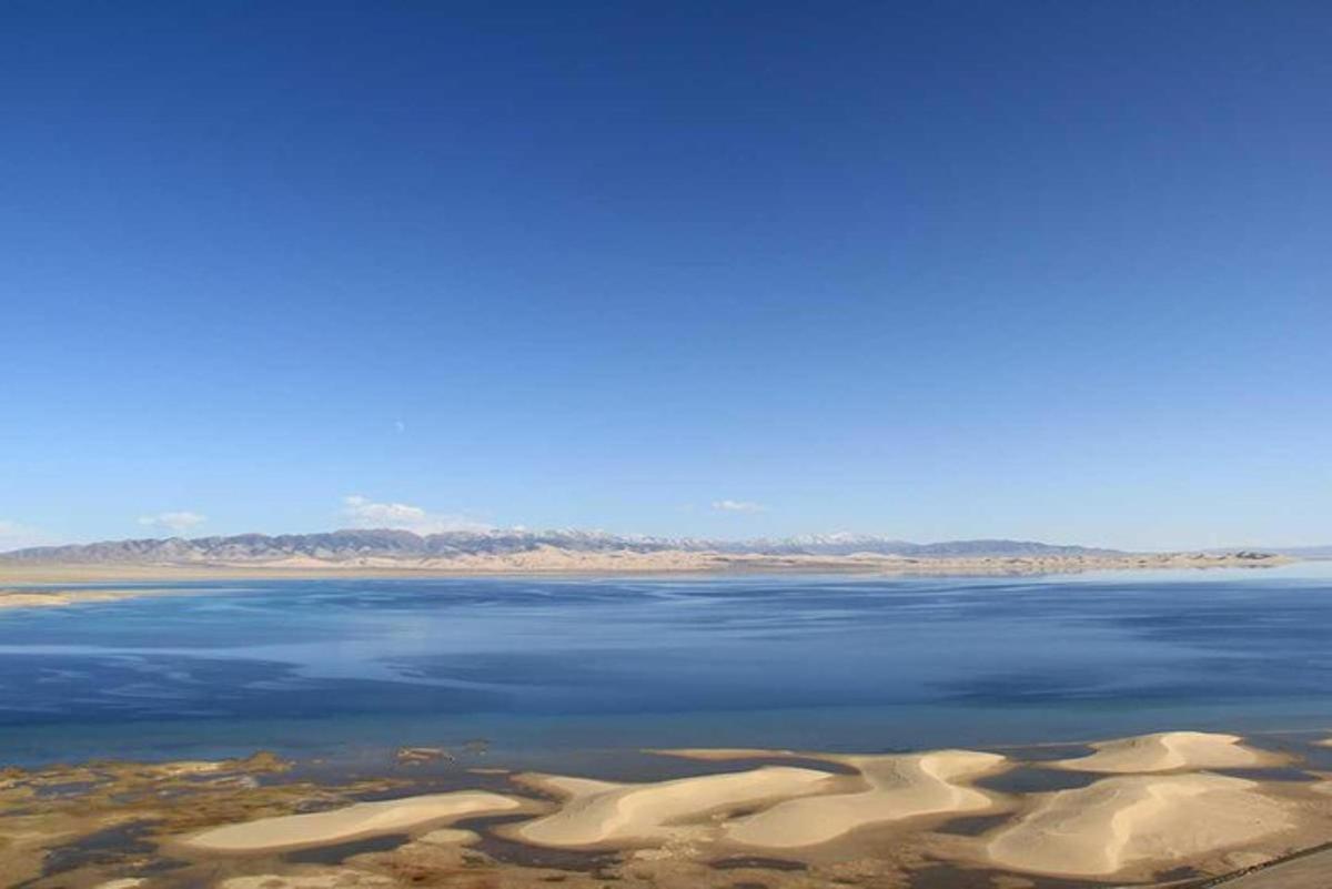 a view of a body of water with sand castles