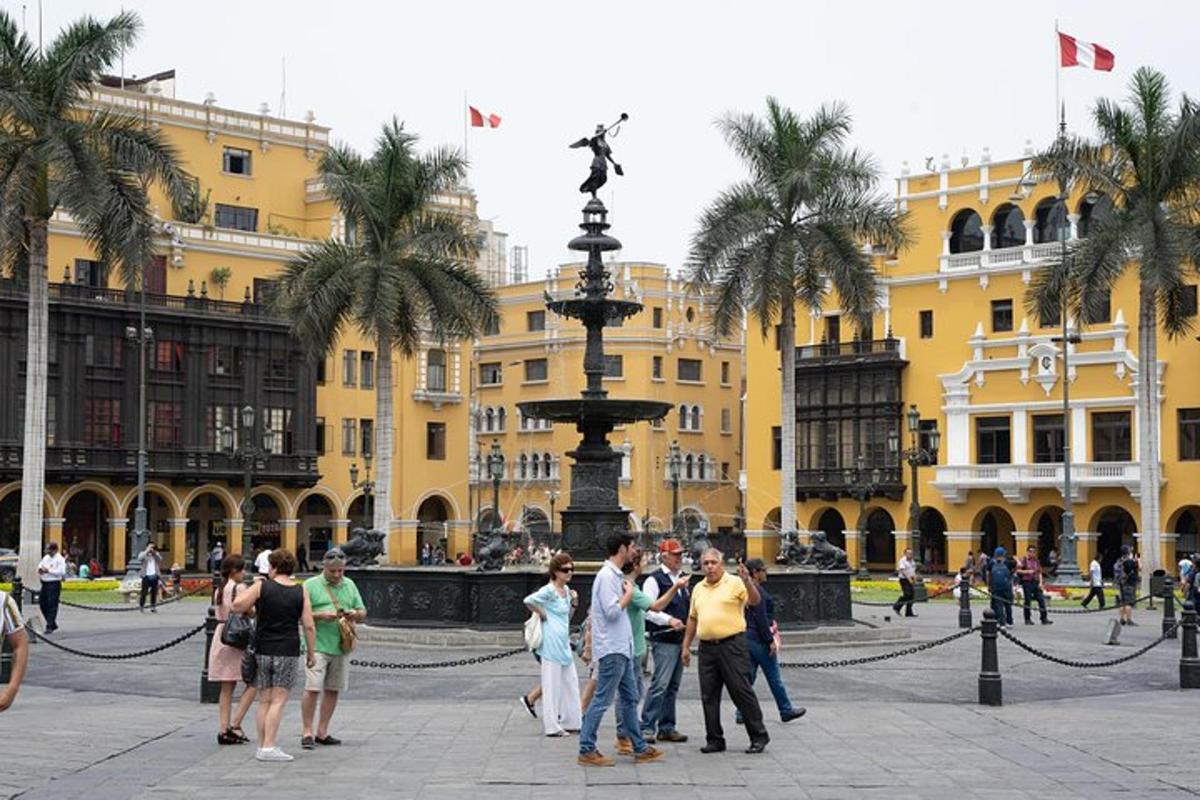 a group of people standing in front of a fountain