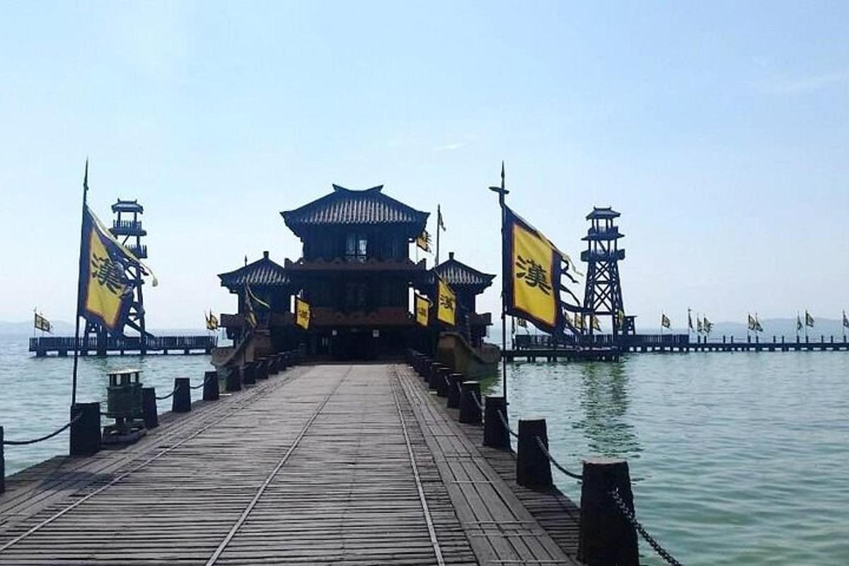 a pier with a building in the middle of the water