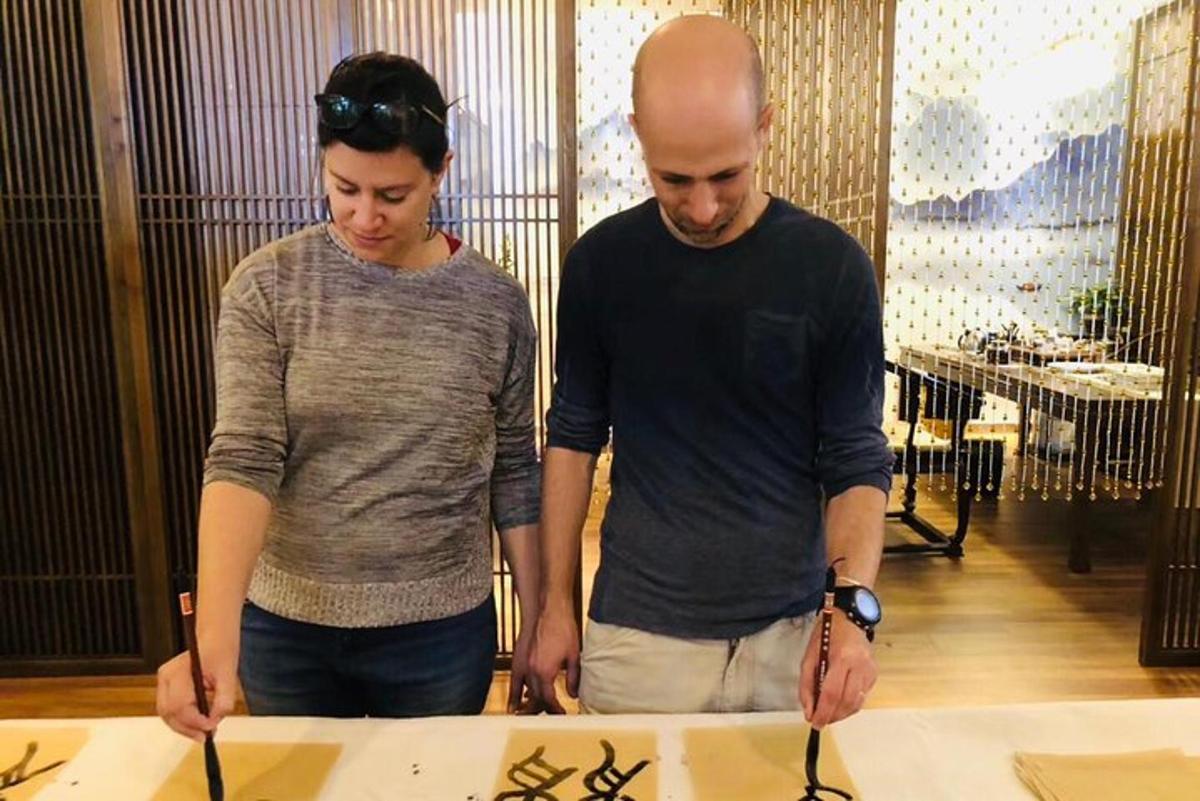 a man and a woman looking at a table