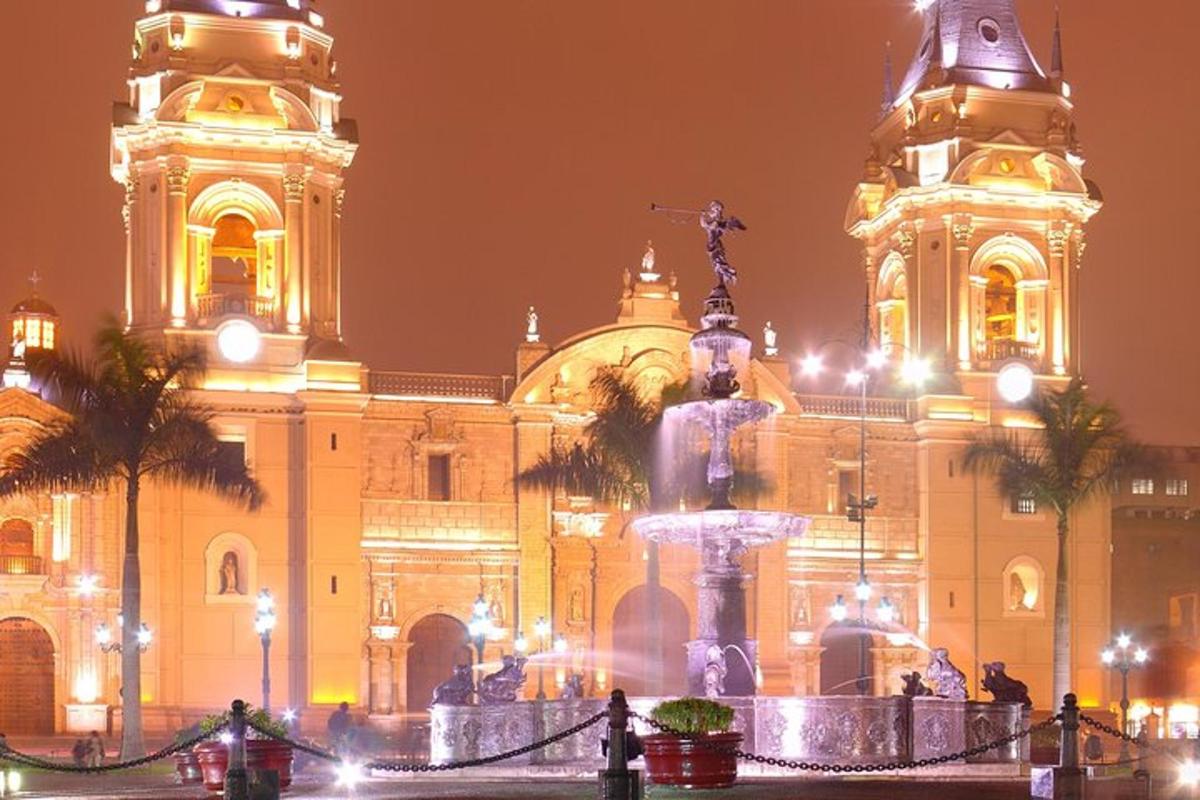 a building with a fountain in front of it at night