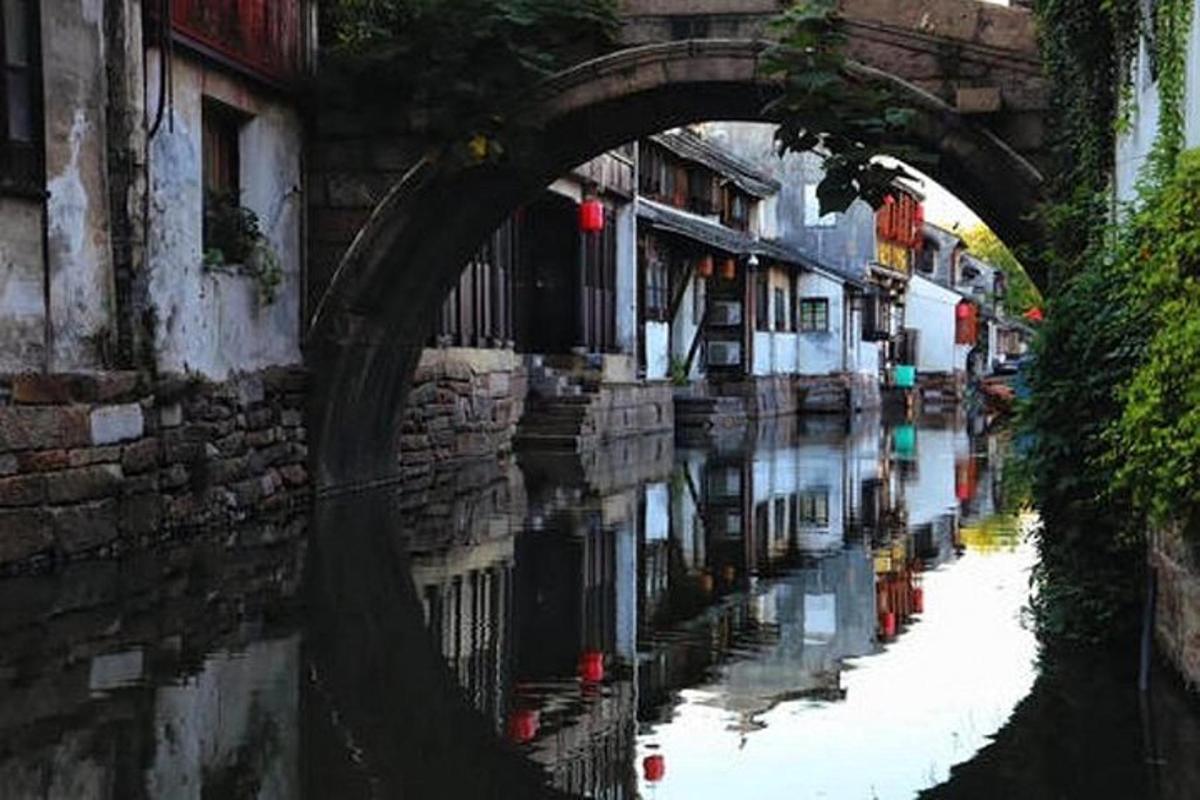 an archway over a canal in a city