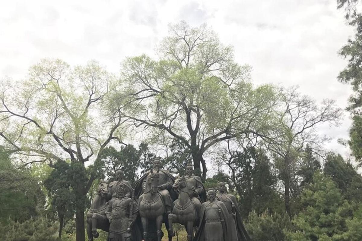 a statue of a group of people riding elephants