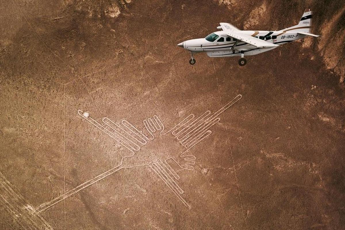 a small plane flying in the air with a drawing of a hand