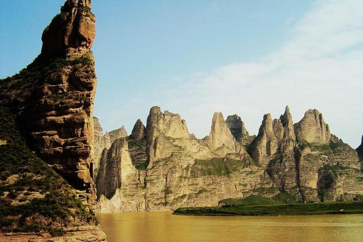 a view of a mountain with water and rocks
