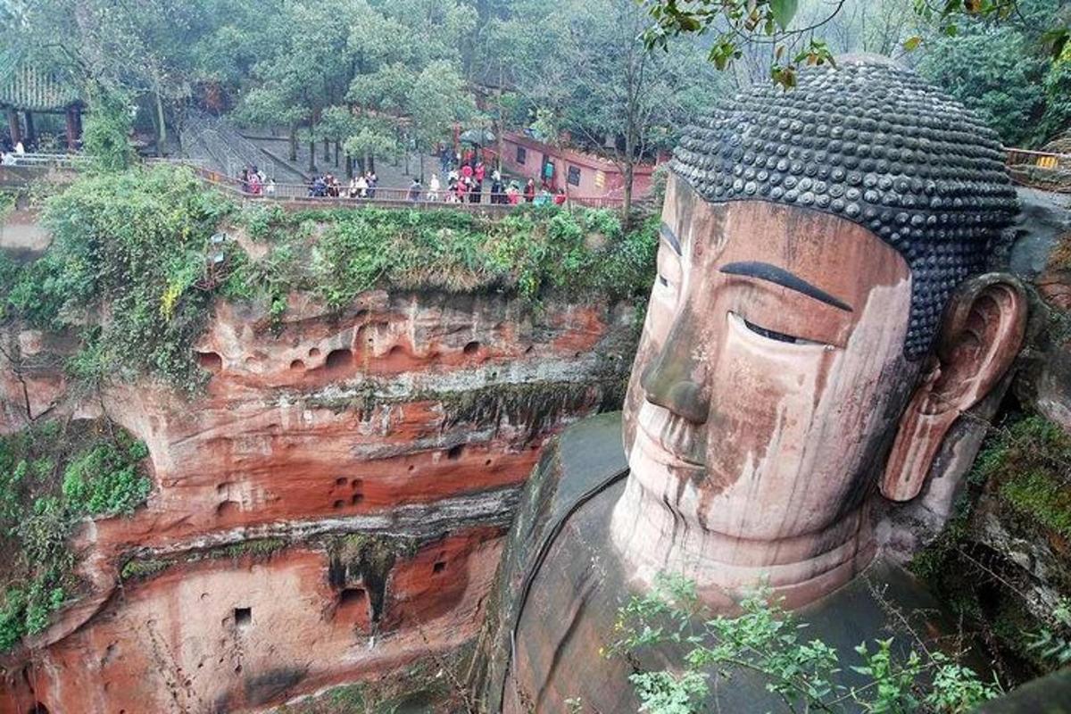 a large statue on the side of a cliff