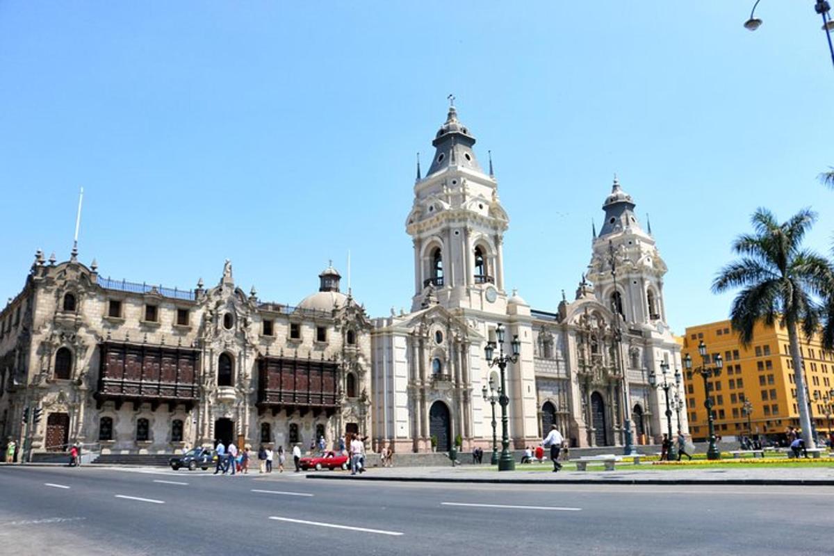 a large white building with a clock tower on a street