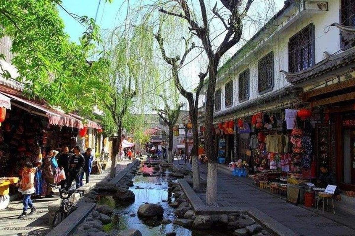 a street with people walking down a street with a pond