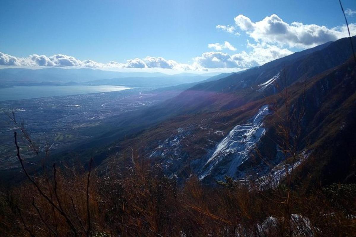 a view of a mountain with a lake in the distance