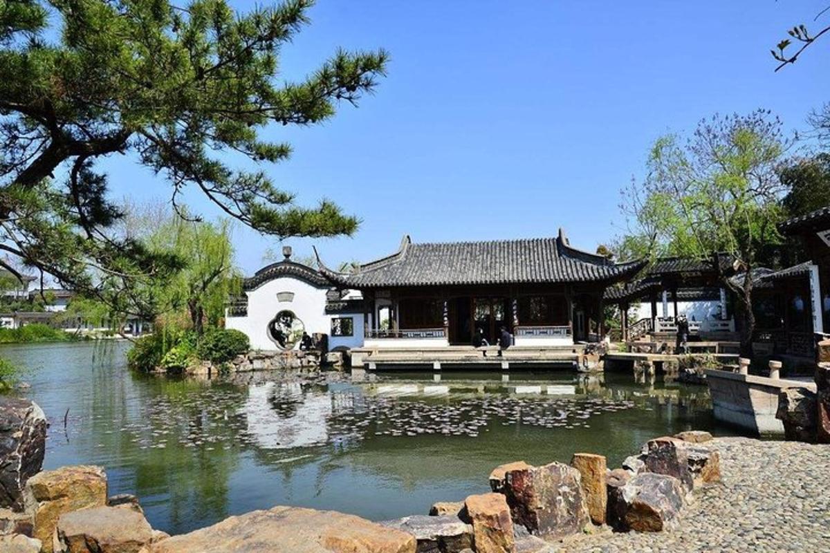 a building with a pond in front of a house