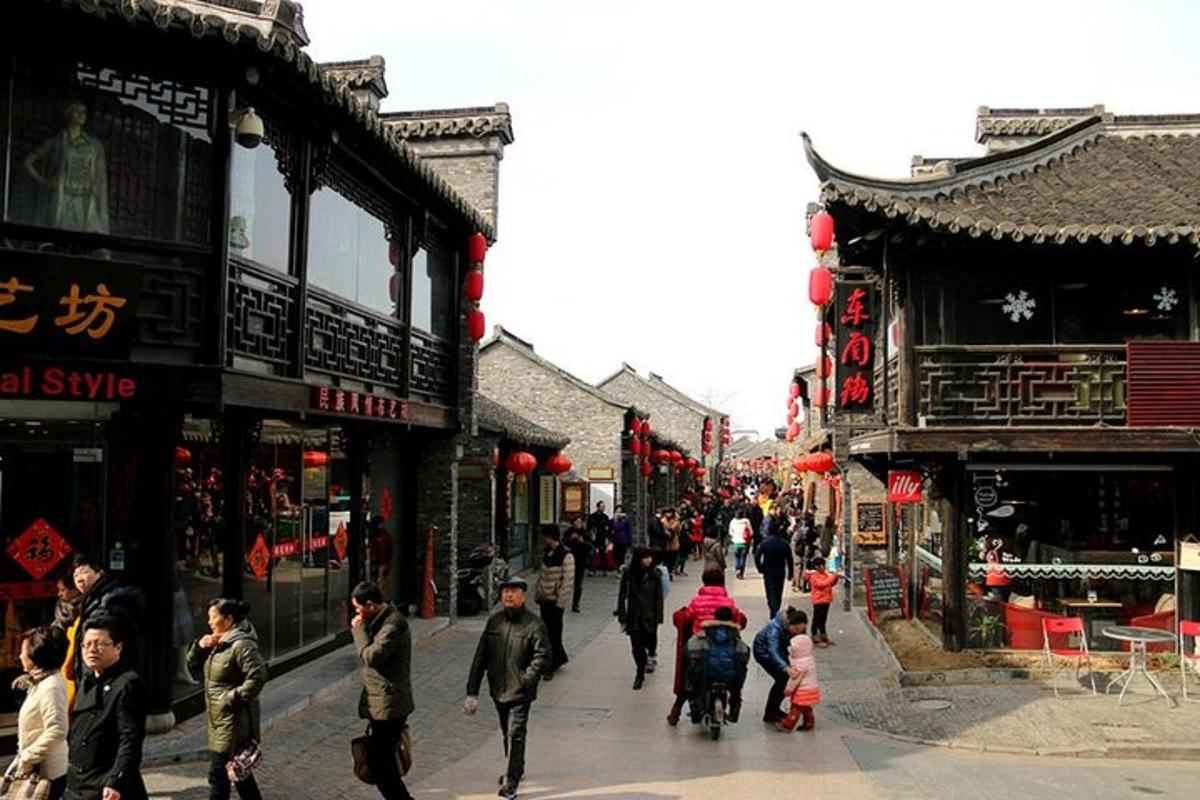 a group of people walking down a street with buildings