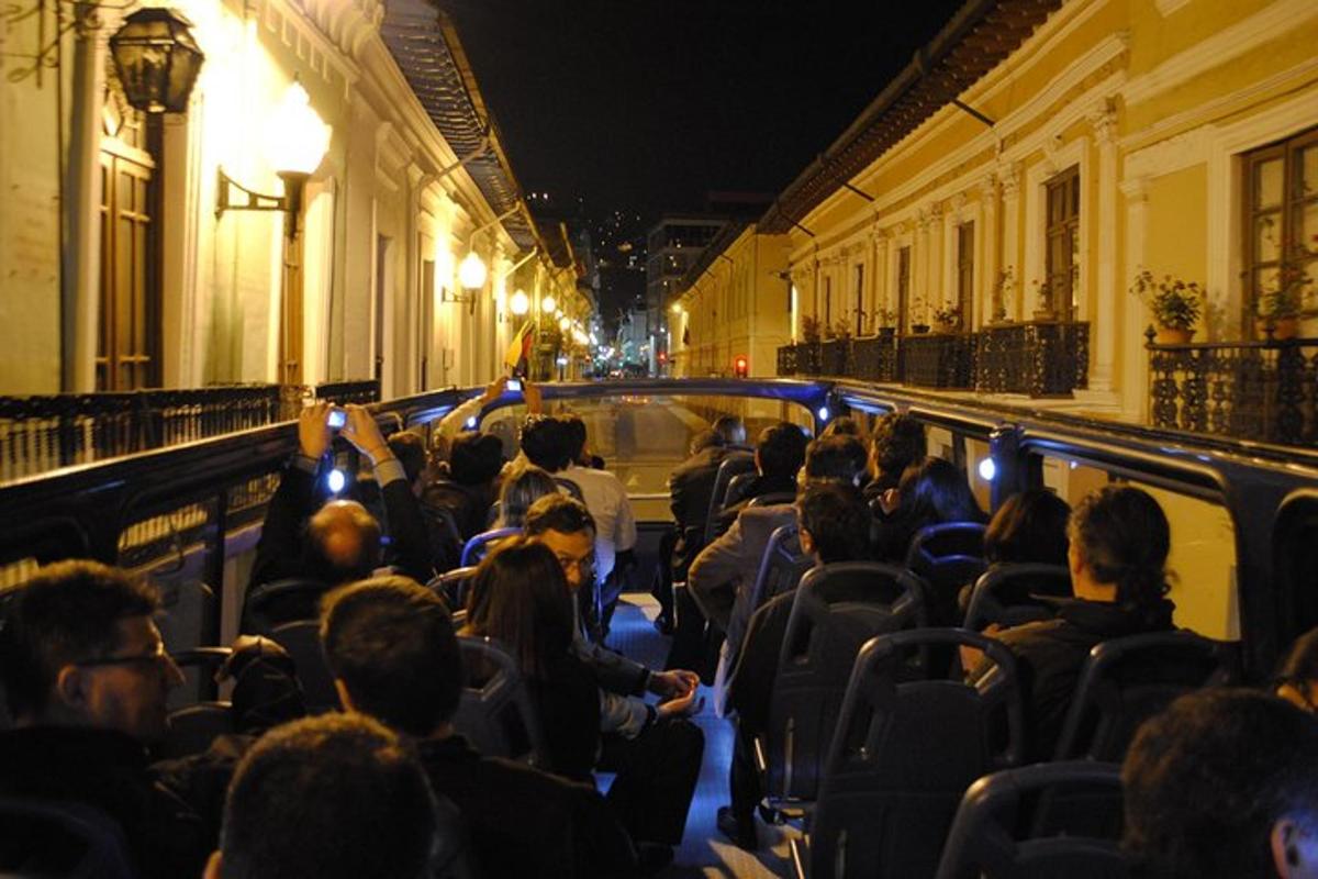 a crowd of people sitting in a bus at night
