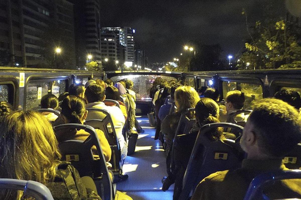 a group of people riding on a bus at night