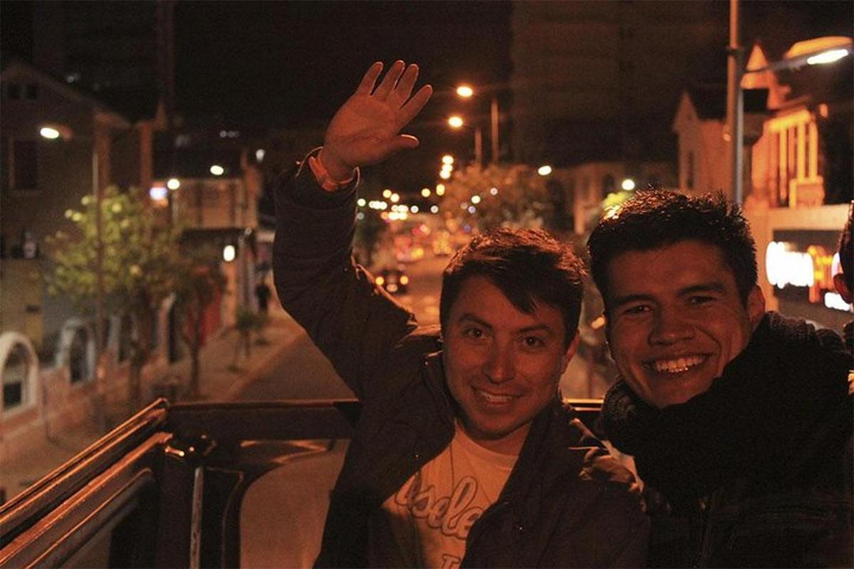 two men standing next to each other with their hand in the air