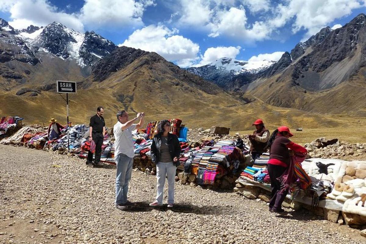 a group of people standing around a market in the mountains