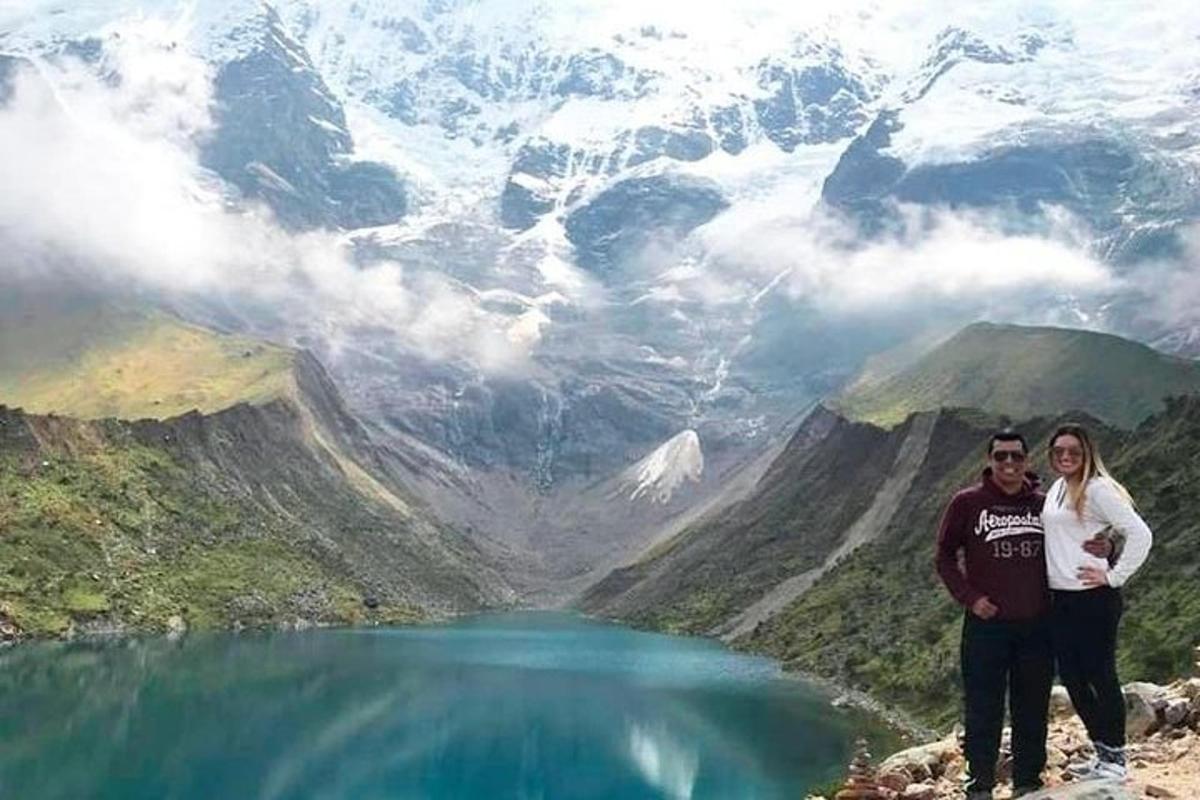 um homem e uma mulher em pé no topo de uma montanha