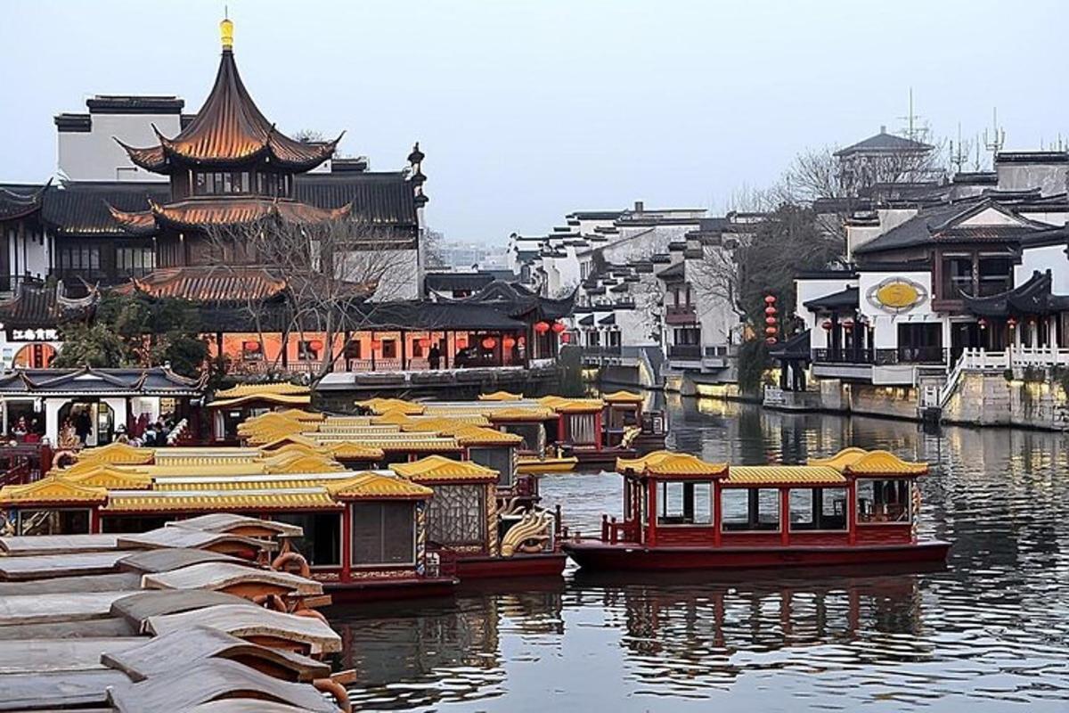 a group of boats in a river with buildings